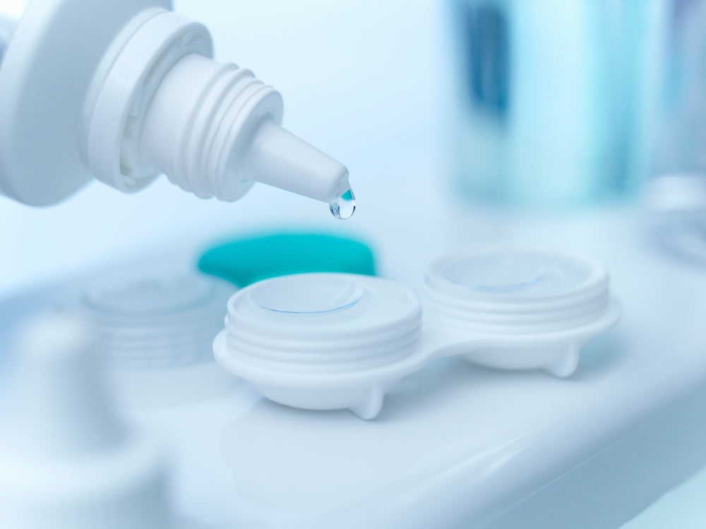 Saline solution is poured over contact lenses