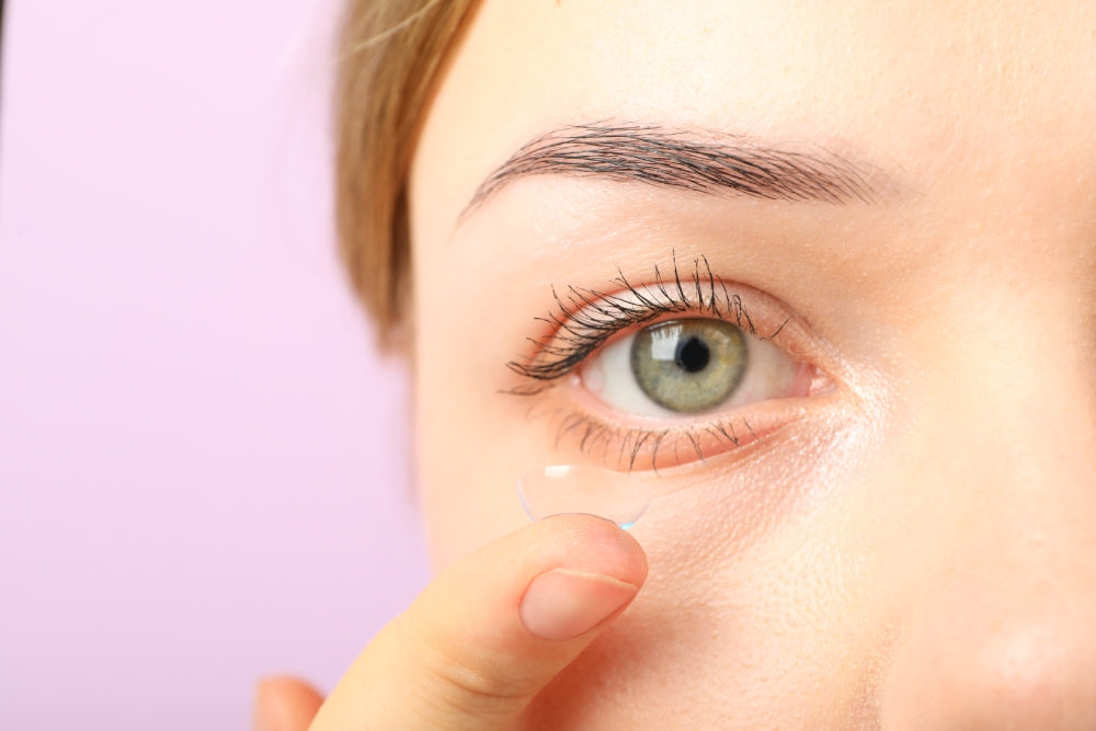 Woman inserts a contact lens